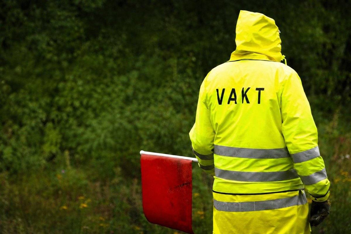 Flaggvakt som dirigerar trafiken vid ett vägarbete i Malmö
